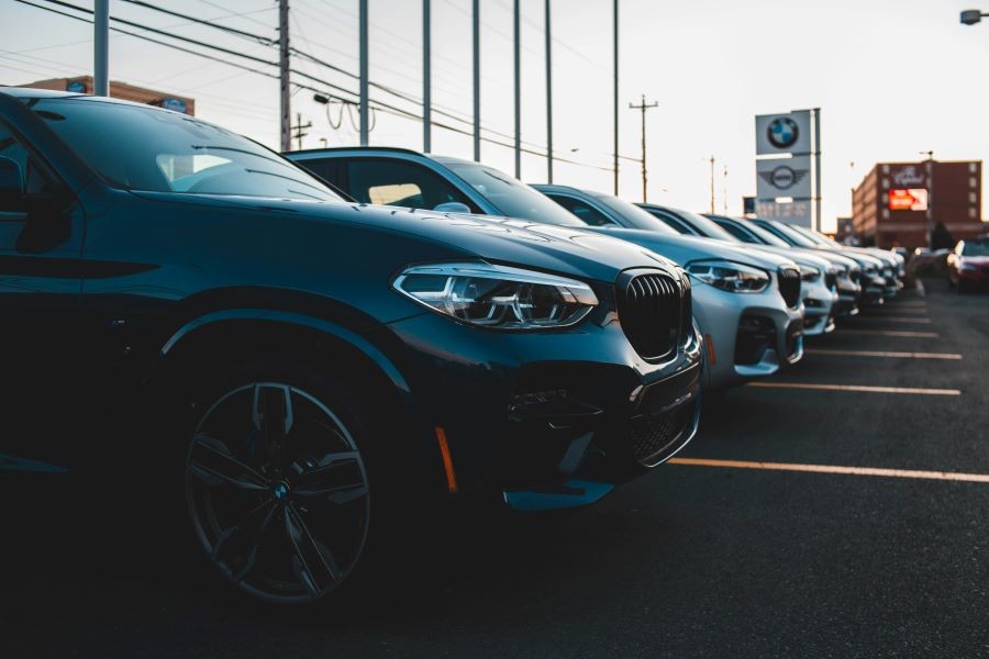 A row of cars in a car dealership.