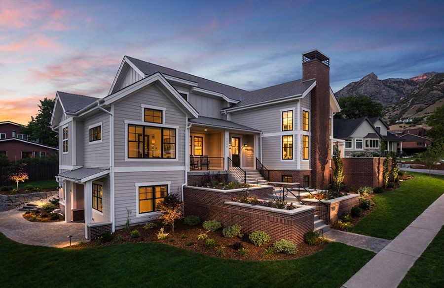 A well-lit house in a residential neighborhood.