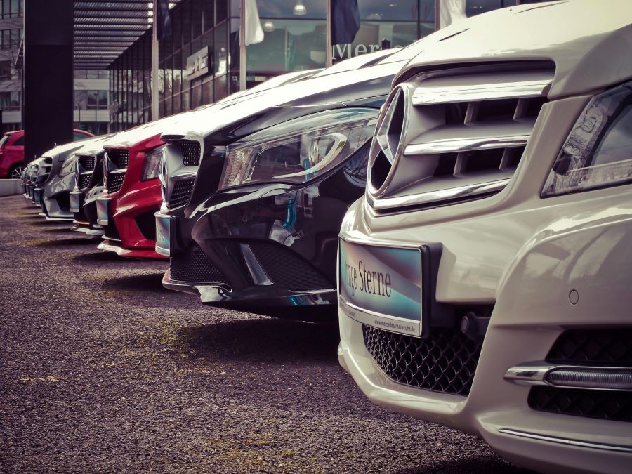 A row of cars at a car dealership.