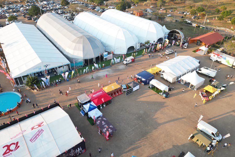 Aerial view of large tents and booths at an outdoor exhibition event.