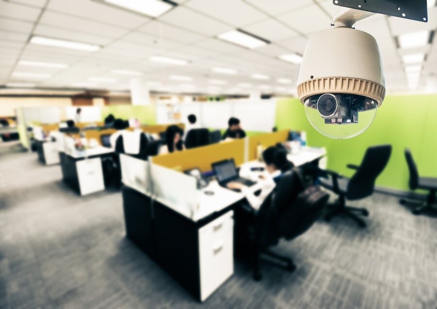  A surveillance camera featuring live security camera monitoring in a commercial office setting.