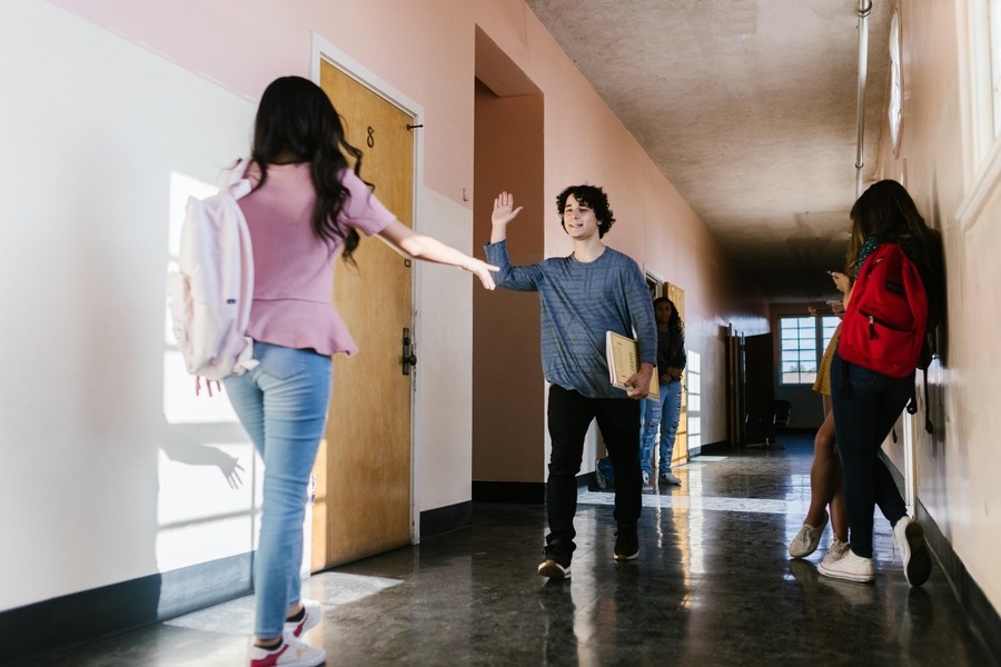 students standing in the corridor of a school
