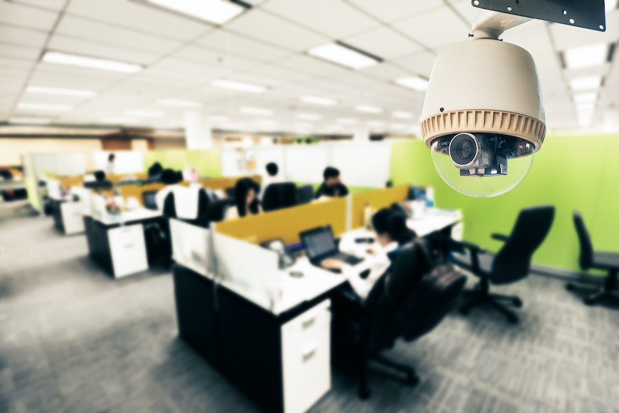 A security camera captures footage of an active office space.