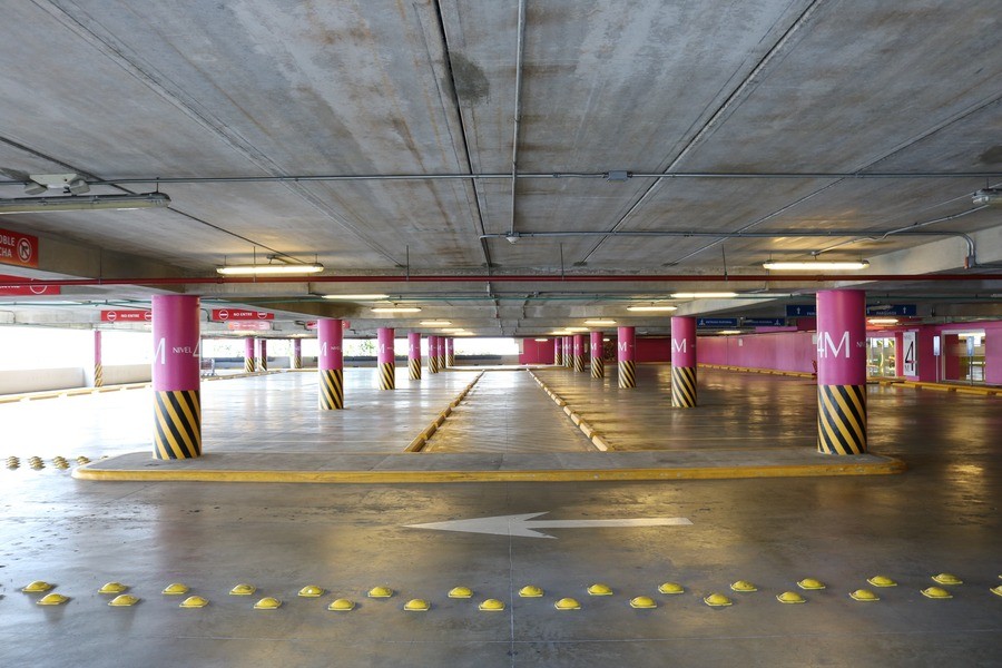 A parking garage brightly lit by the sun.  Author: Leon Posada